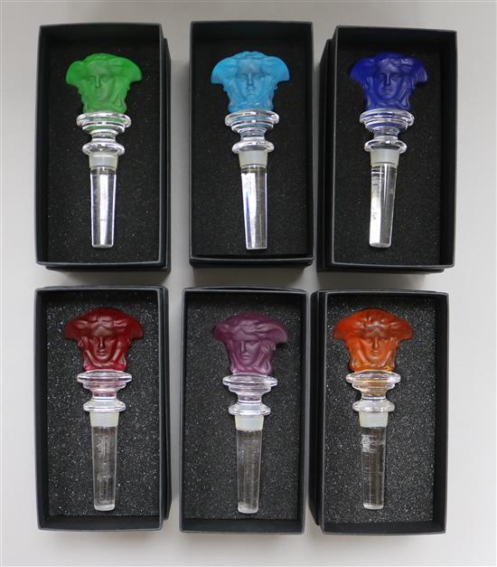 A set of six Rosenthal for Versace vari coloured Medusa head glass bottle stoppers